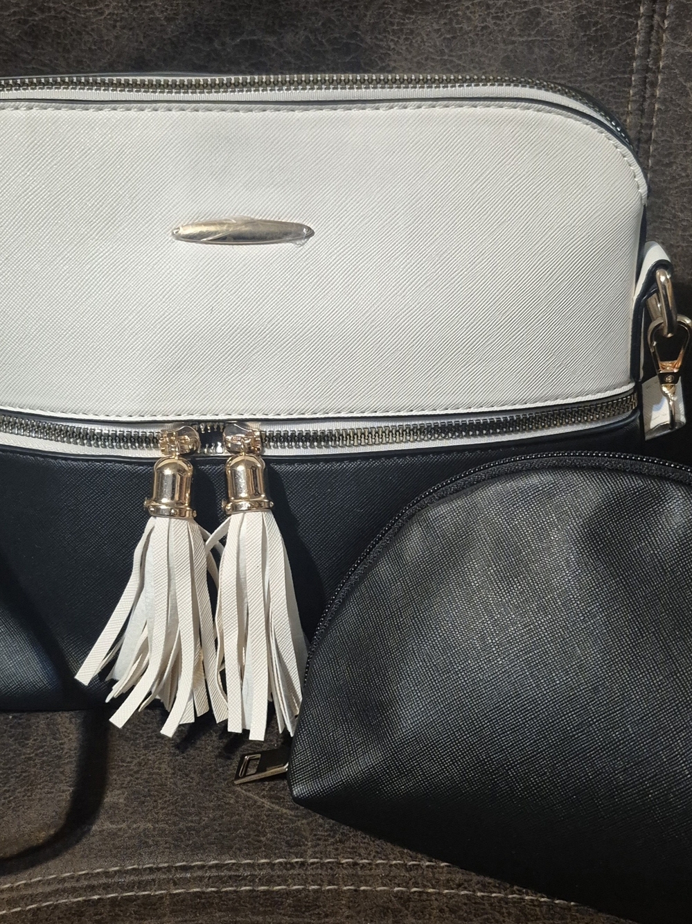 Two-Tone Black and White Crossbody Bag with Tassel Accents